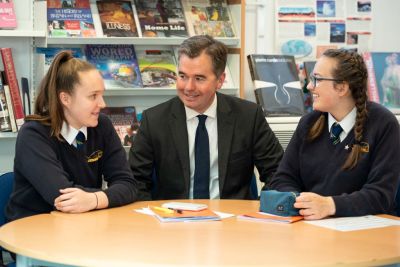 John Marston with students in the school library