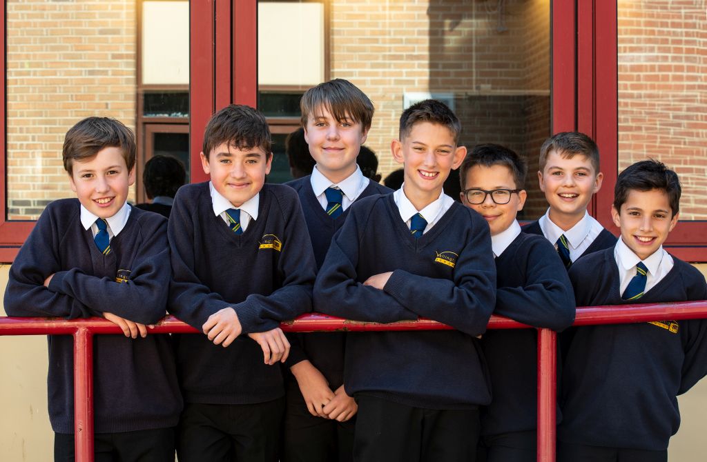 Boys standing in front of a school building