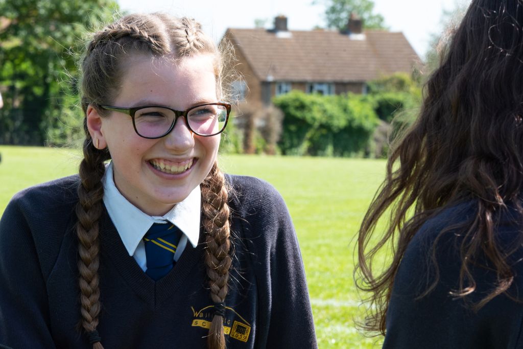 Girl smiling on the school field.