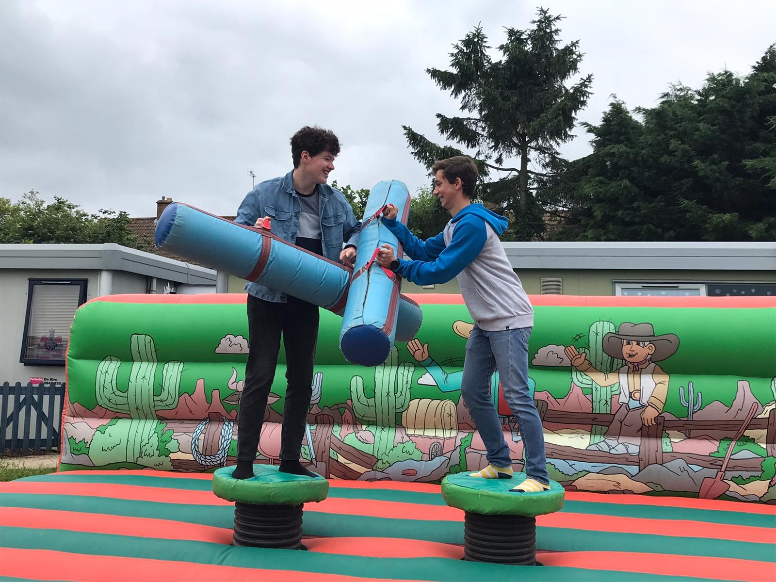 Boys fighting with inflatables