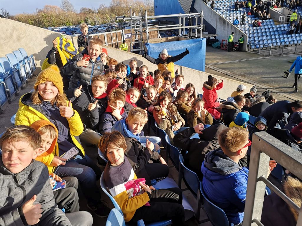 Students in the Kassam Stadium, posing for the camera
