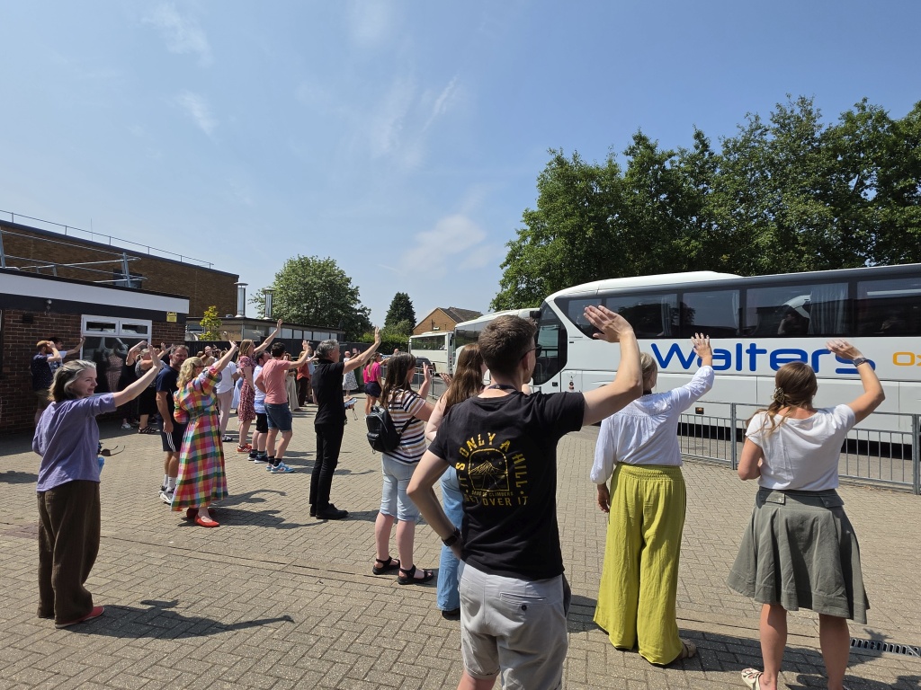 Staff waving the buses off for summer